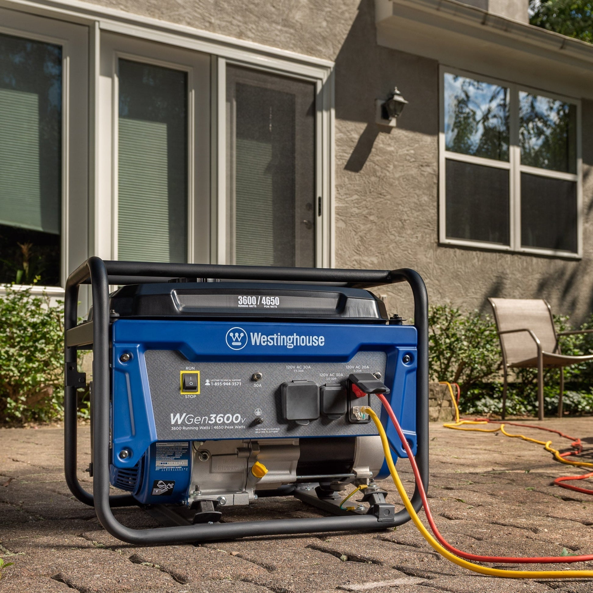 Westinghouse | WGen3600v portable generator sitting on patio with cords plugged in.