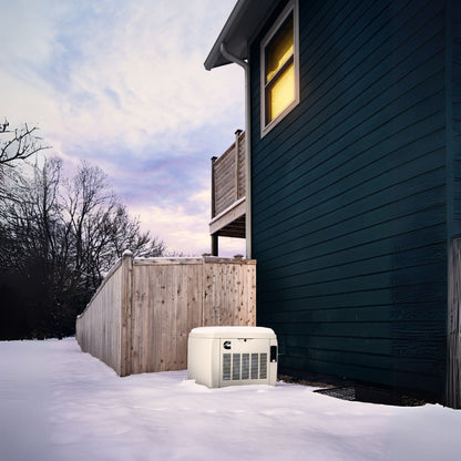 Cummins RS17A 17kW Home Standby Generator installed outside in the snow zoomed-out view