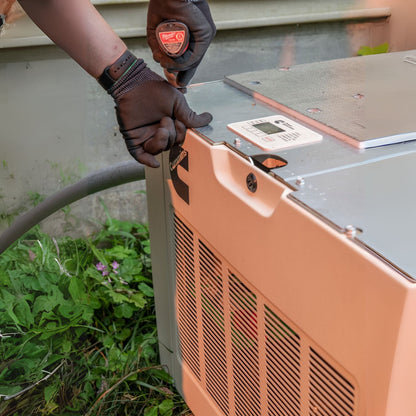 Man securing bolts on Cummins RS13A 13kW Home Standby Generator installation